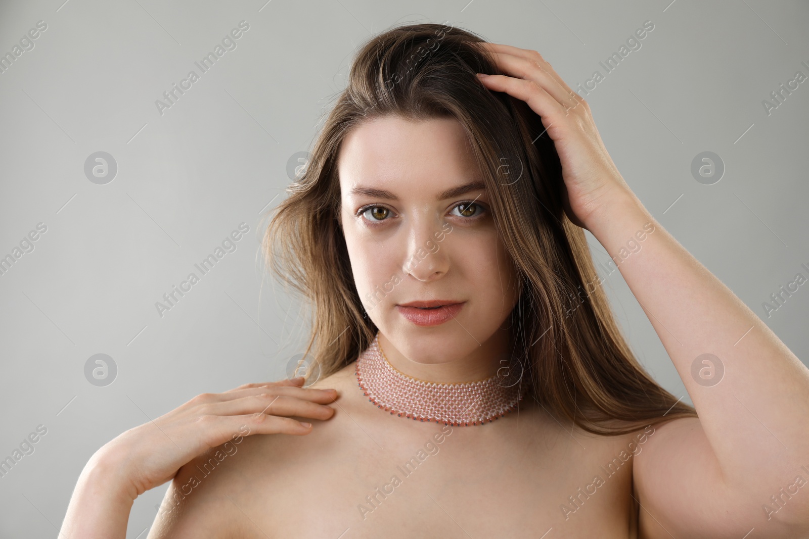 Photo of Portrait of beautiful young woman on grey background