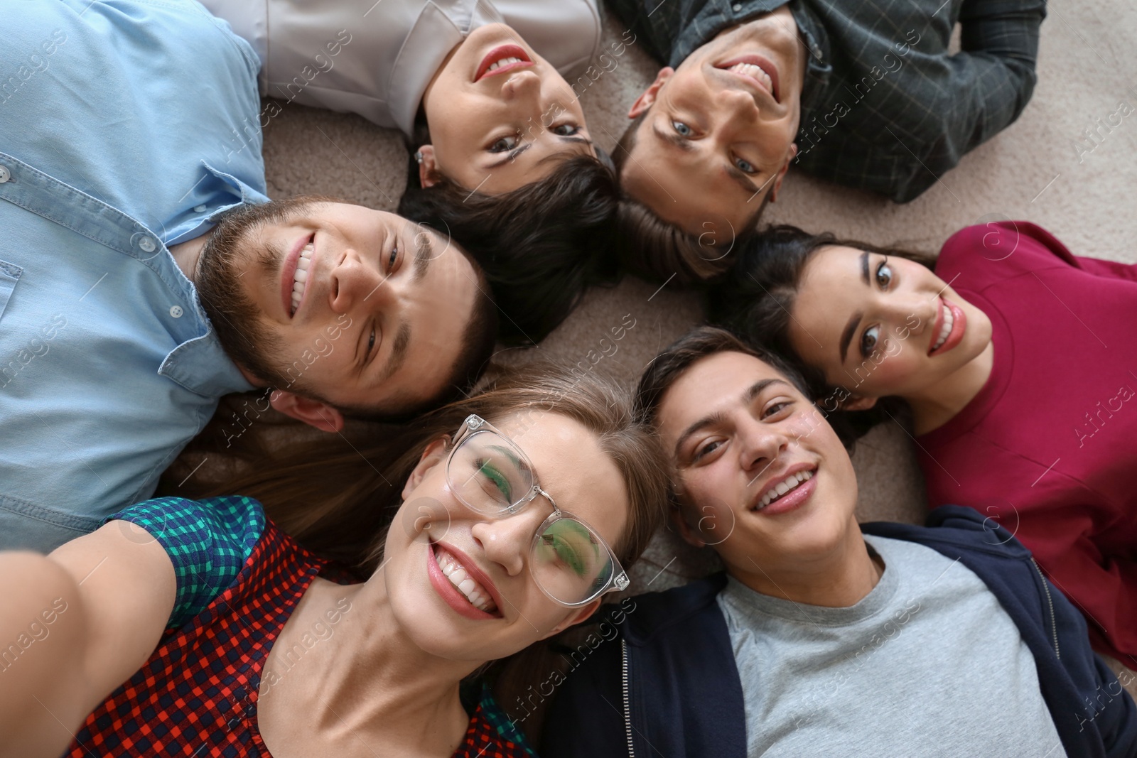 Photo of Happy friends taking selfie indoors