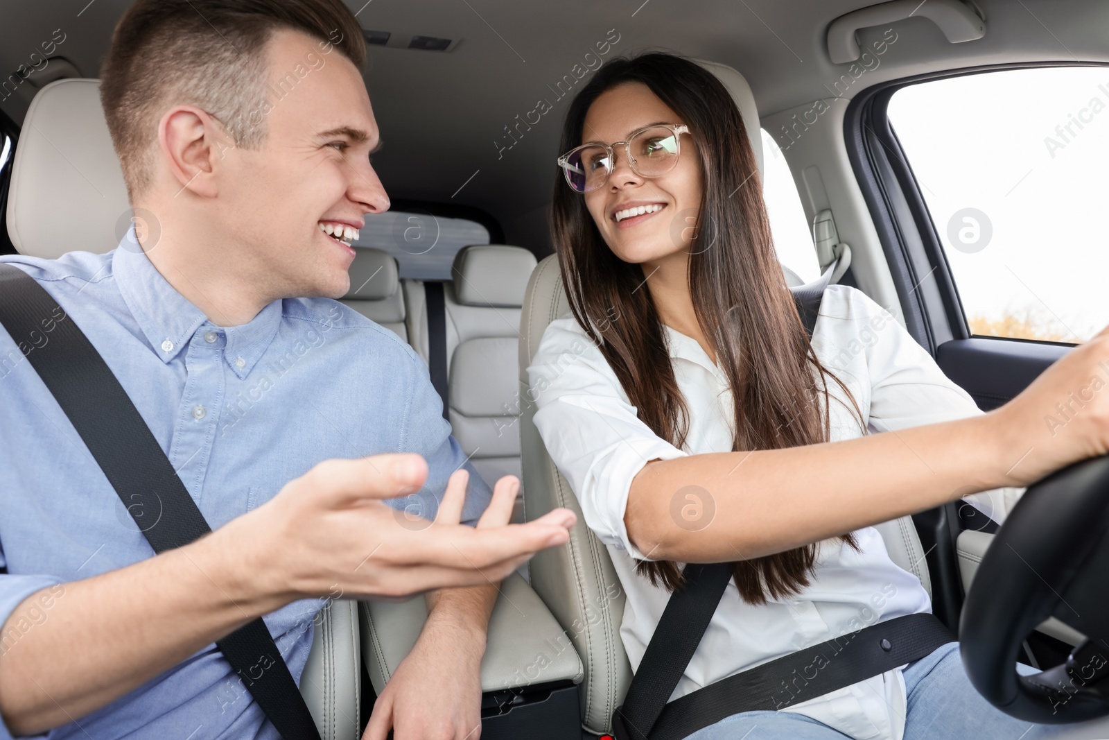 Photo of Happy young couple travelling together by car