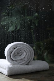 Photo of White terry towels on table in bathroom, space for text