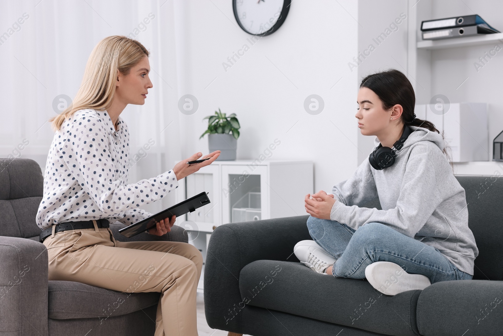 Photo of Psychologist working with teenage girl in office