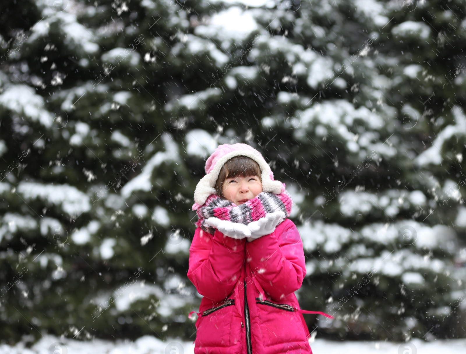 Photo of Little girl playing outdoors on snowy day