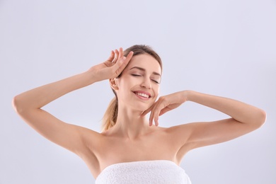 Photo of Young woman with silky skin on light background