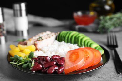 Photo of Delicious rice with beans served on grey table, closeup