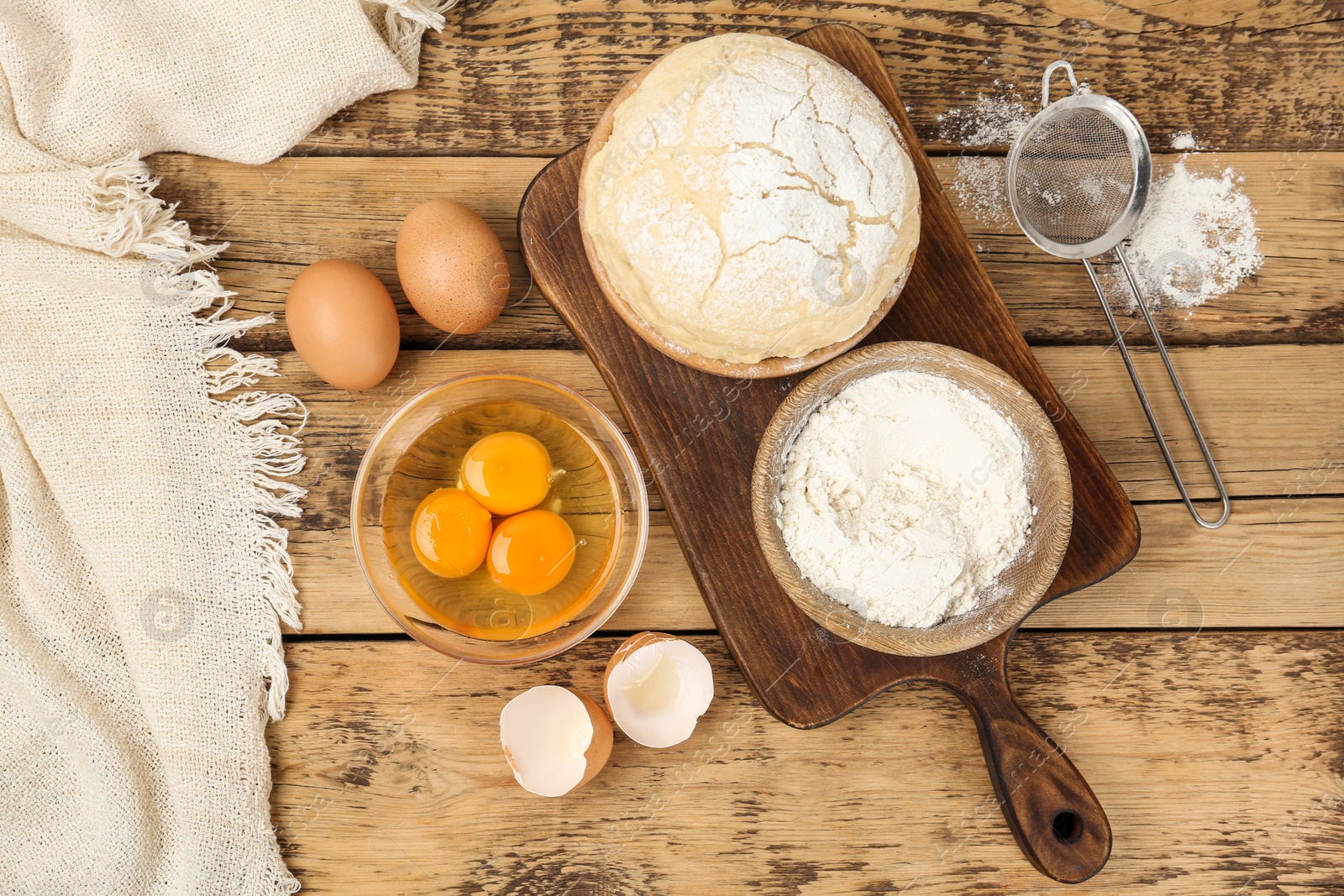 Photo of Flat lay composition with raw eggs and other ingredients on wooden table. Baking pie