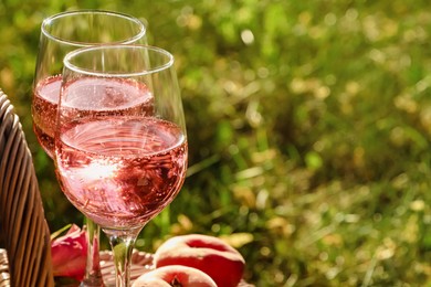 Photo of Glassesdelicious rose wine outside, closeup. Space for text