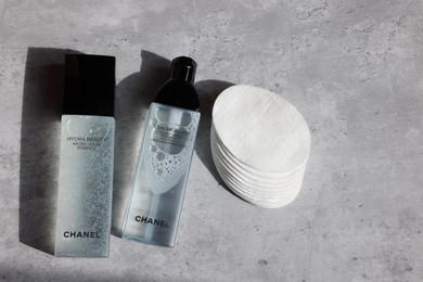 Leiden, Netherlands - July 14, 2022: Chanel cosmetic products and cotton pads on grey table, flat lay