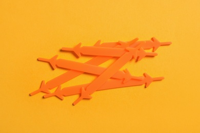 Photo of Orange silicone shoelaces on yellow background, flat lay