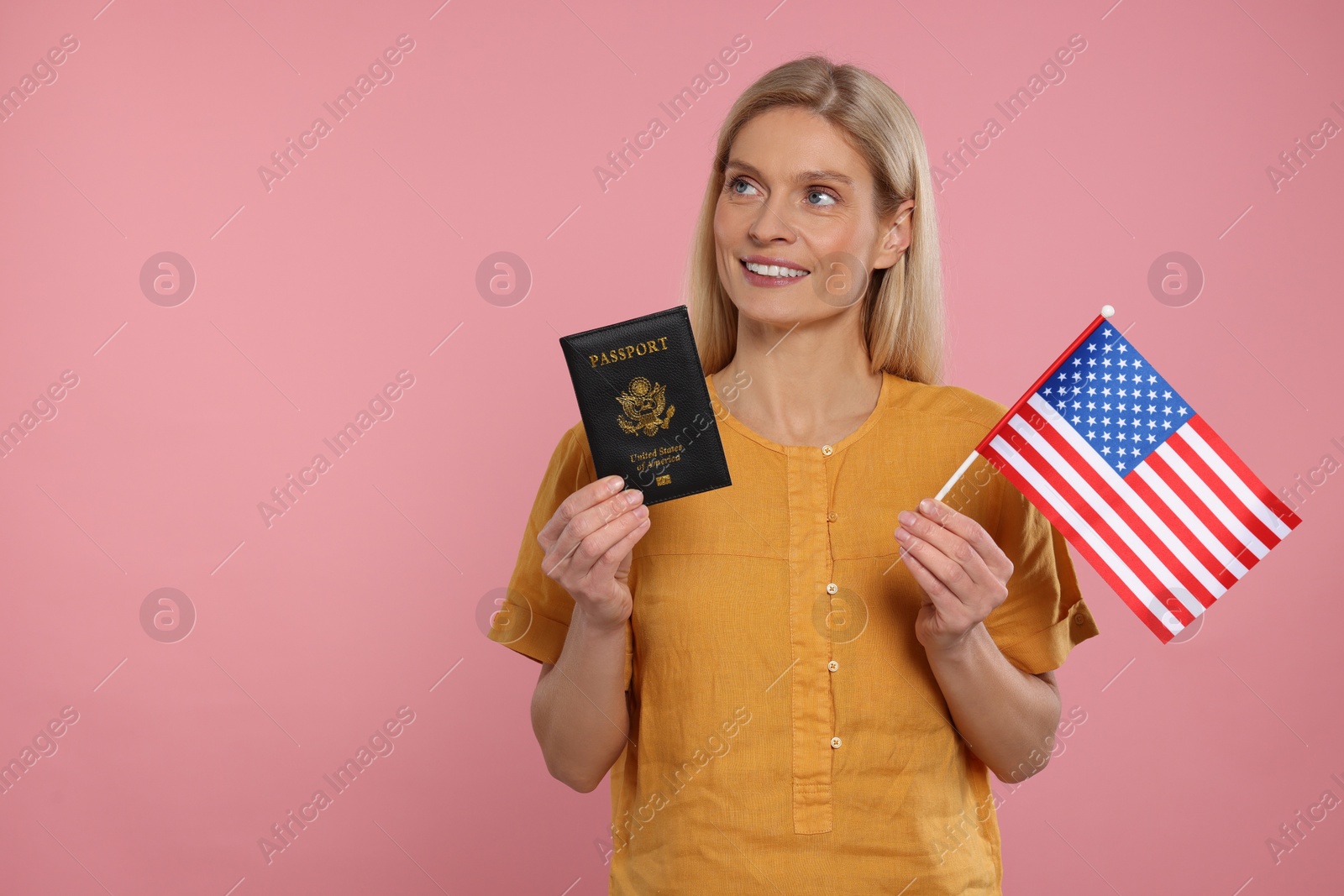 Photo of Immigration. Happy woman with passport and American flag on pink background, space for text