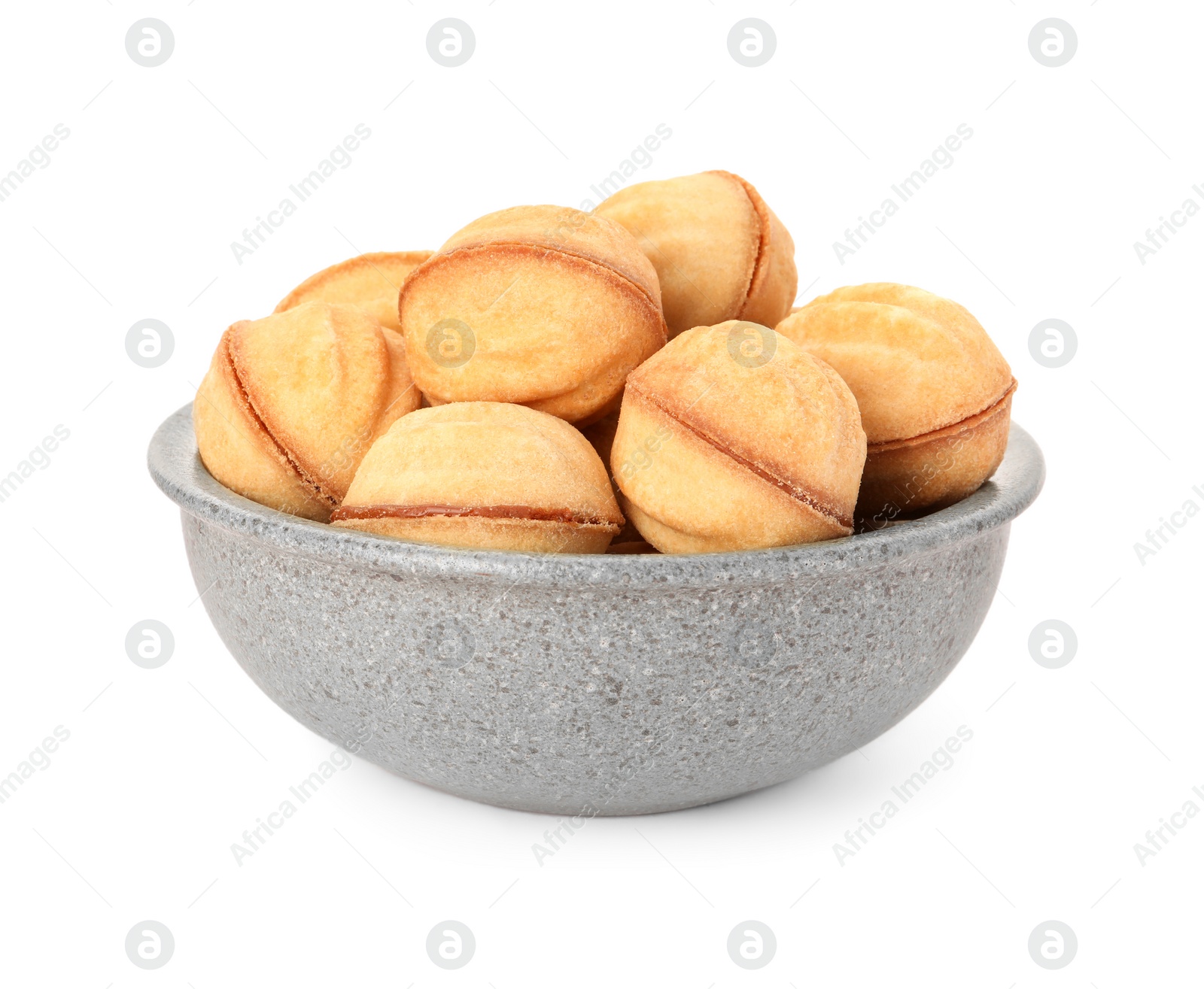 Photo of Bowl of delicious nut shaped cookies with condensed milk on white background