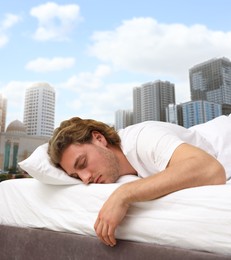 Man sleeping in bed and beautiful view of cityscape on background. Good sleep despite of urban bustle