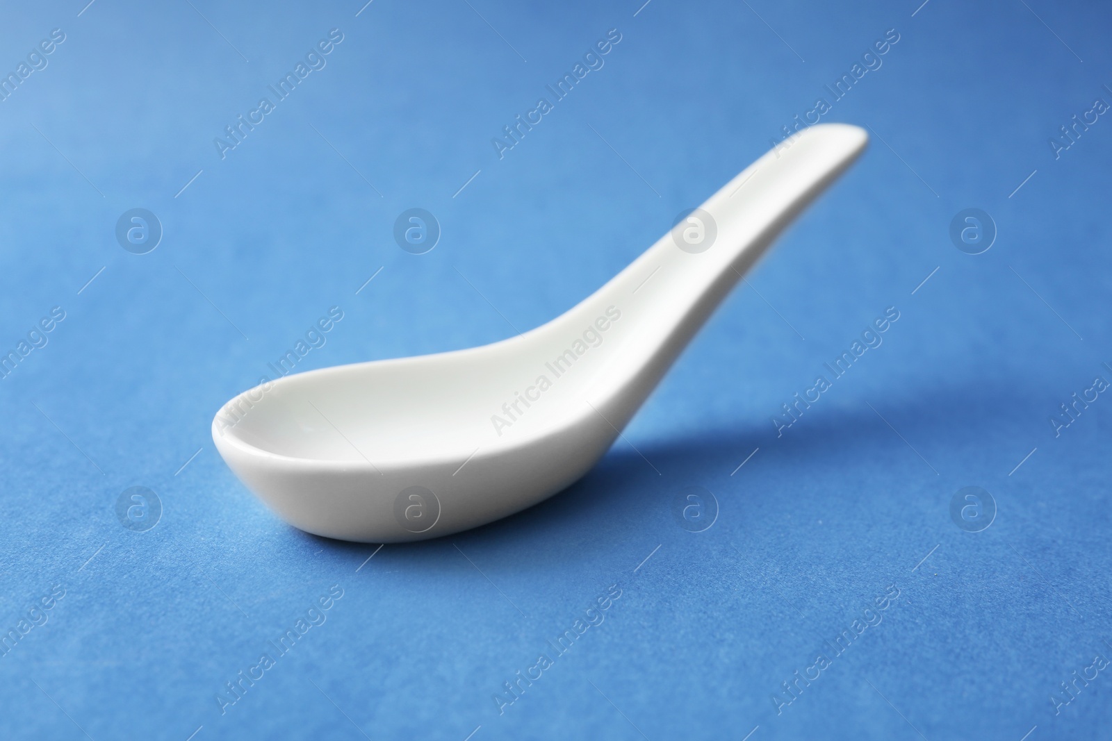 Photo of Clean Miso soup spoon on blue background