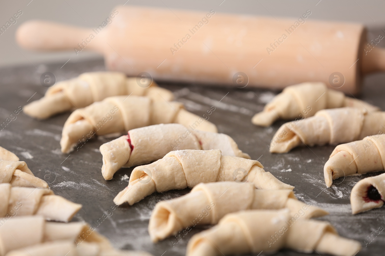 Photo of Raw croissants on grey table