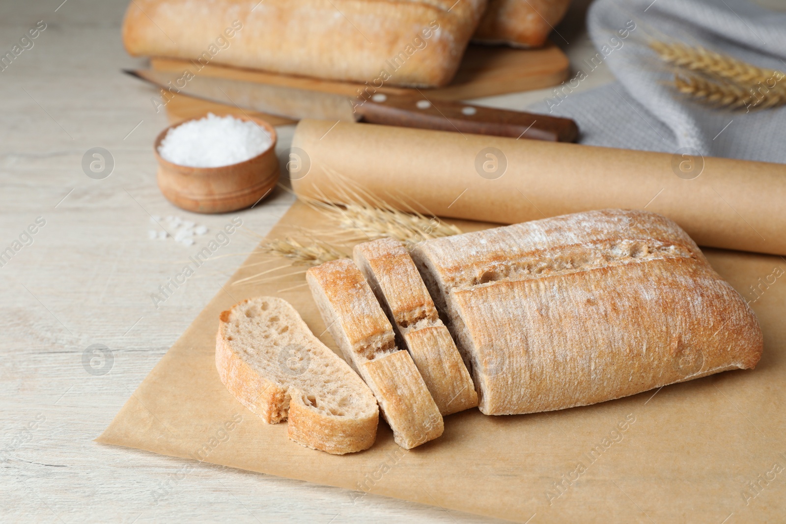 Photo of Fresh crispy ciabatta on white wooden table