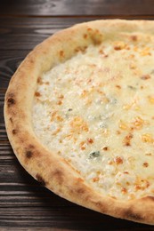 Photo of Delicious cheese pizza on wooden table, closeup