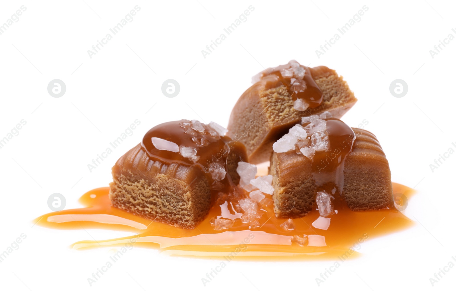 Photo of Delicious salted caramel with sauce on white background