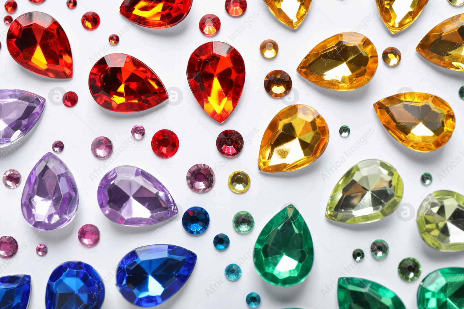 Photo of Different beautiful gemstones on white background, top view