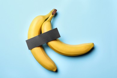 Photo of Bananas with censor bar on turquoise background, flat lay