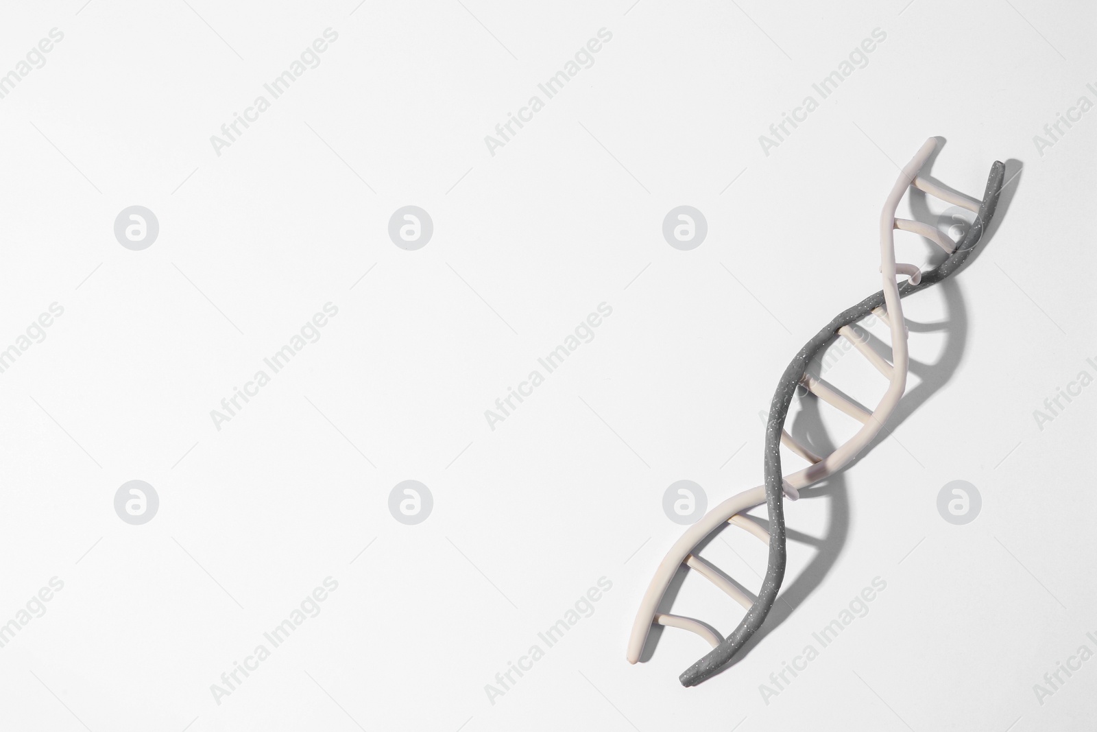 Photo of DNA molecule model made of colorful plasticine on white background, top view. Space for text