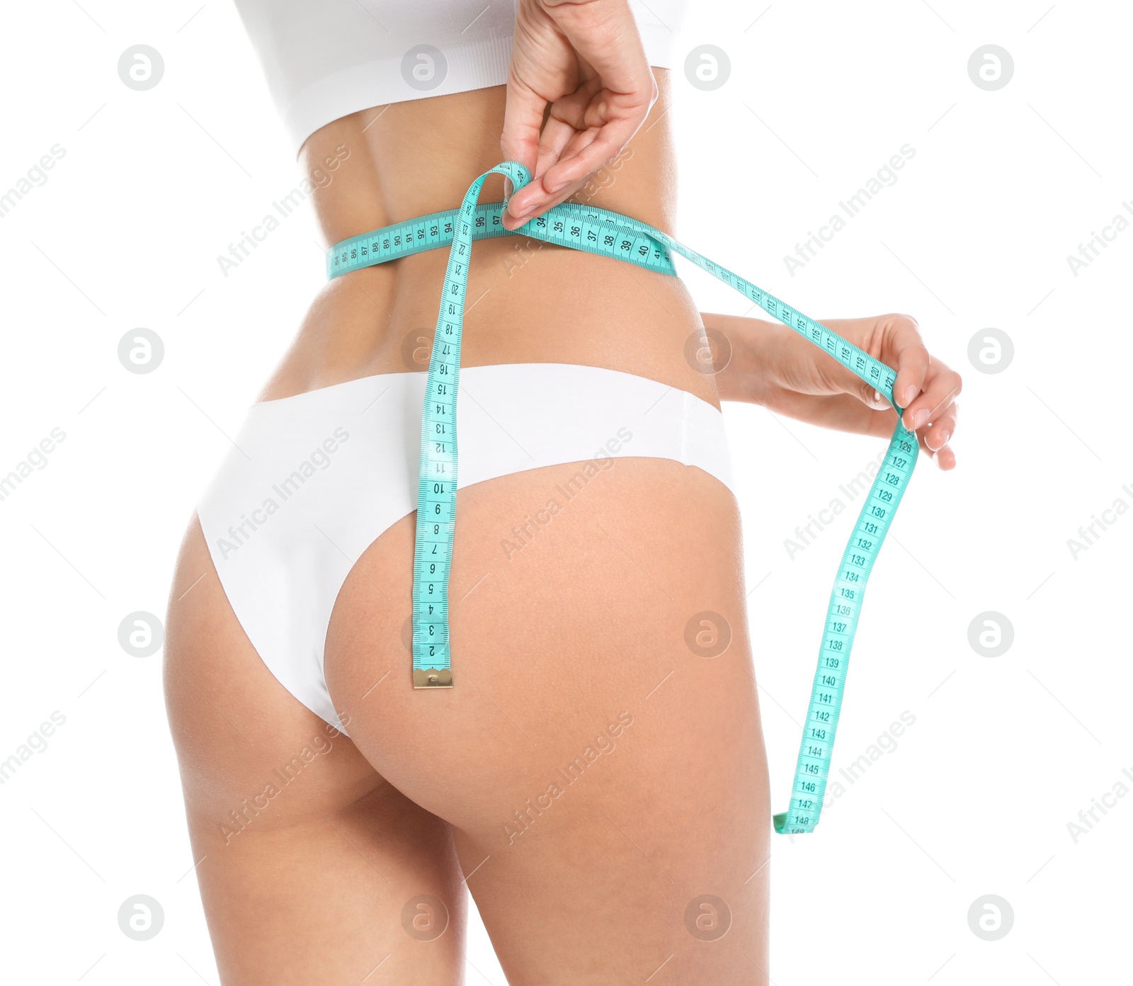 Photo of Slim young woman with smooth gentle skin in underwear measuring body on white background, closeup