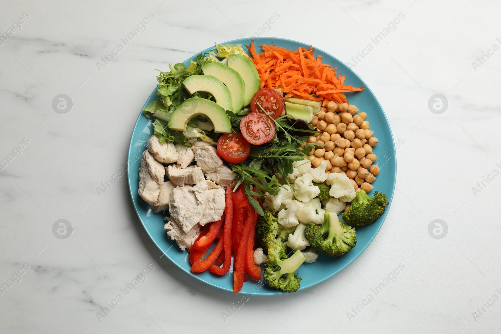 Photo of Balanced diet and healthy foods. Plate with different delicious products on white marble table, top view