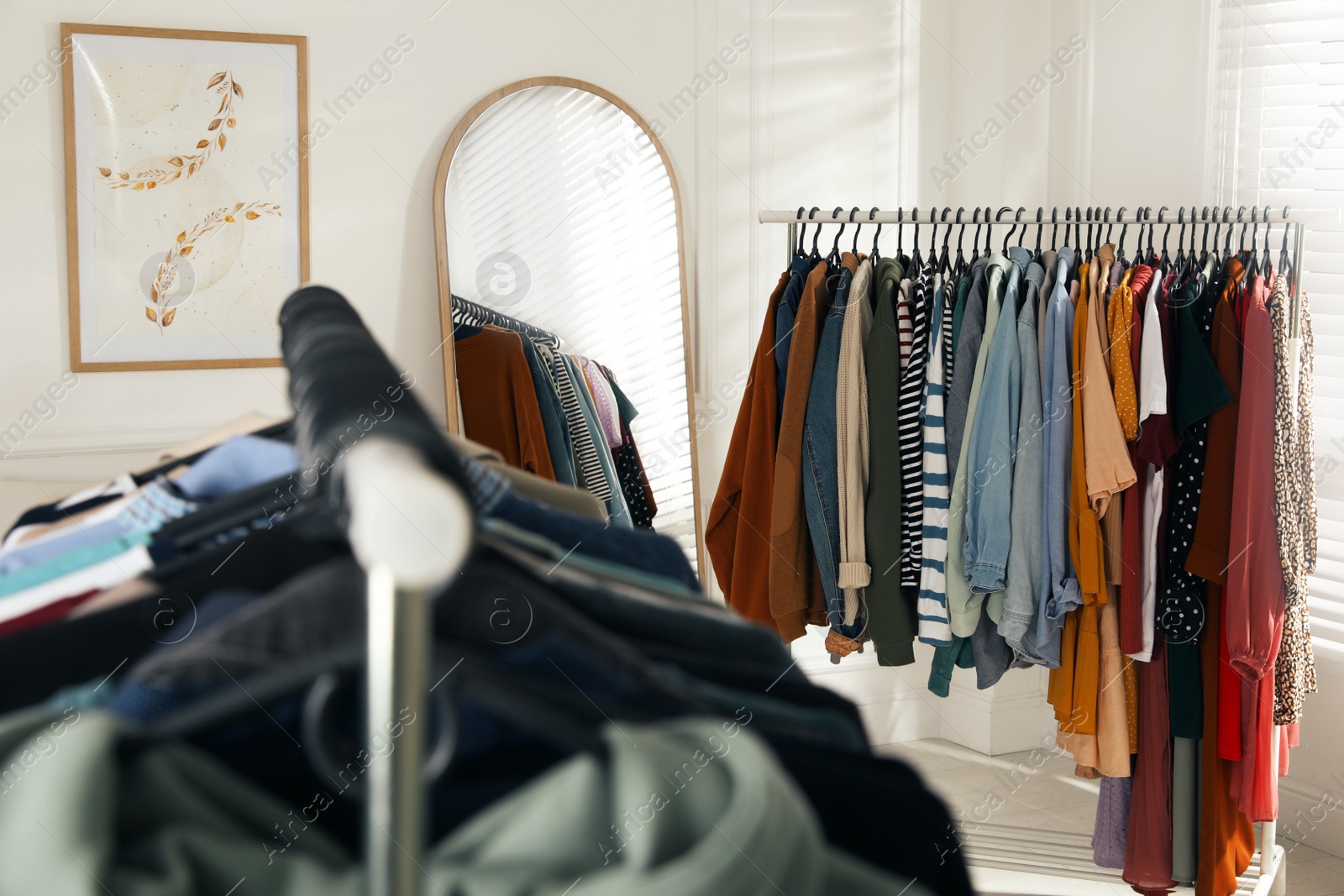 Photo of Racks with stylish clothes indoors. Fast fashion