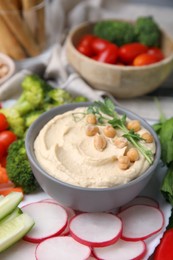 Photo of Plate with delicious hummus and fresh vegetables on table