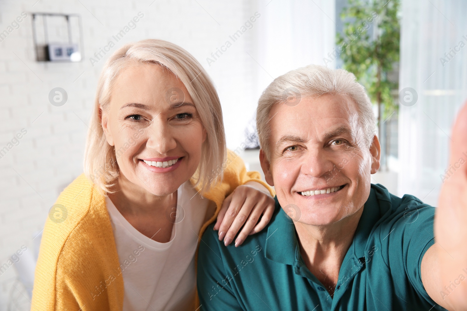 Photo of Mature couple using video chat at home, view from web camera