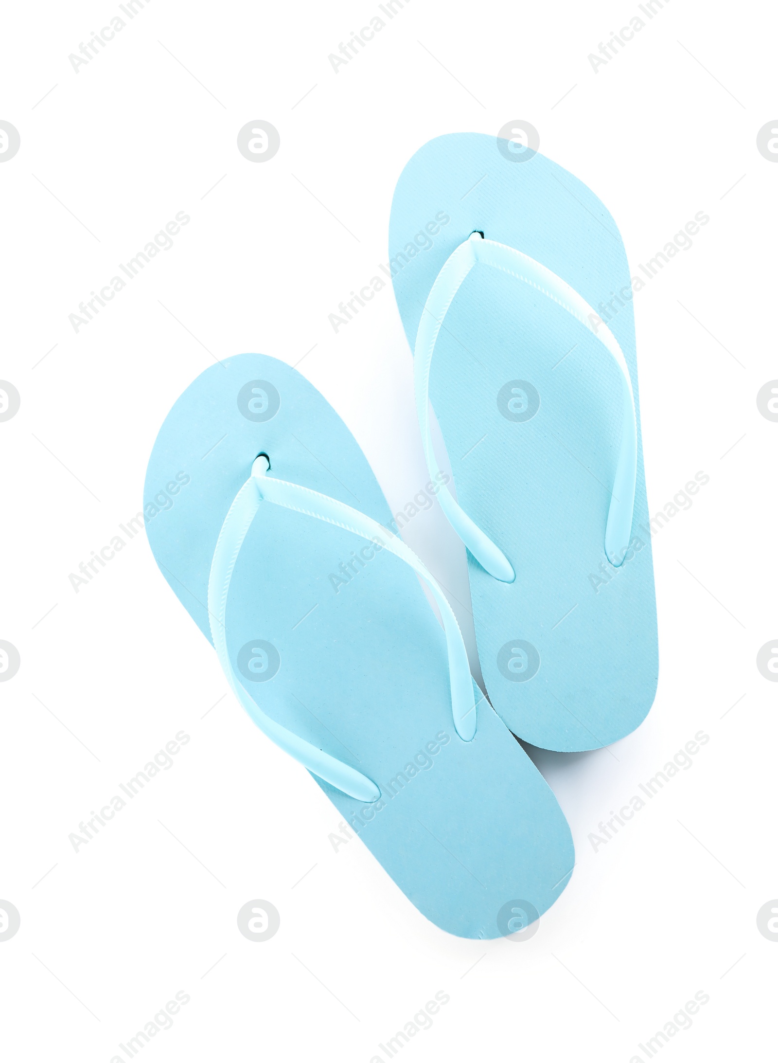 Photo of Light blue flip flops isolated on white, top view. Beach accessory