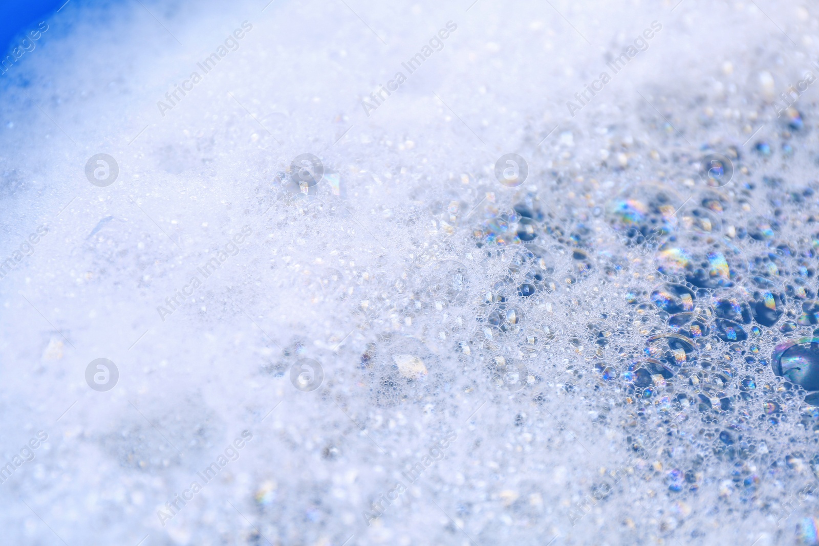 Photo of Detergent foam as background, closeup. Hand washing laundry