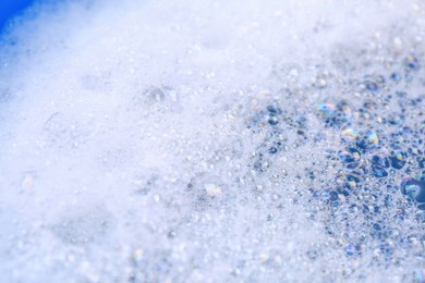 Photo of Detergent foam as background, closeup. Hand washing laundry