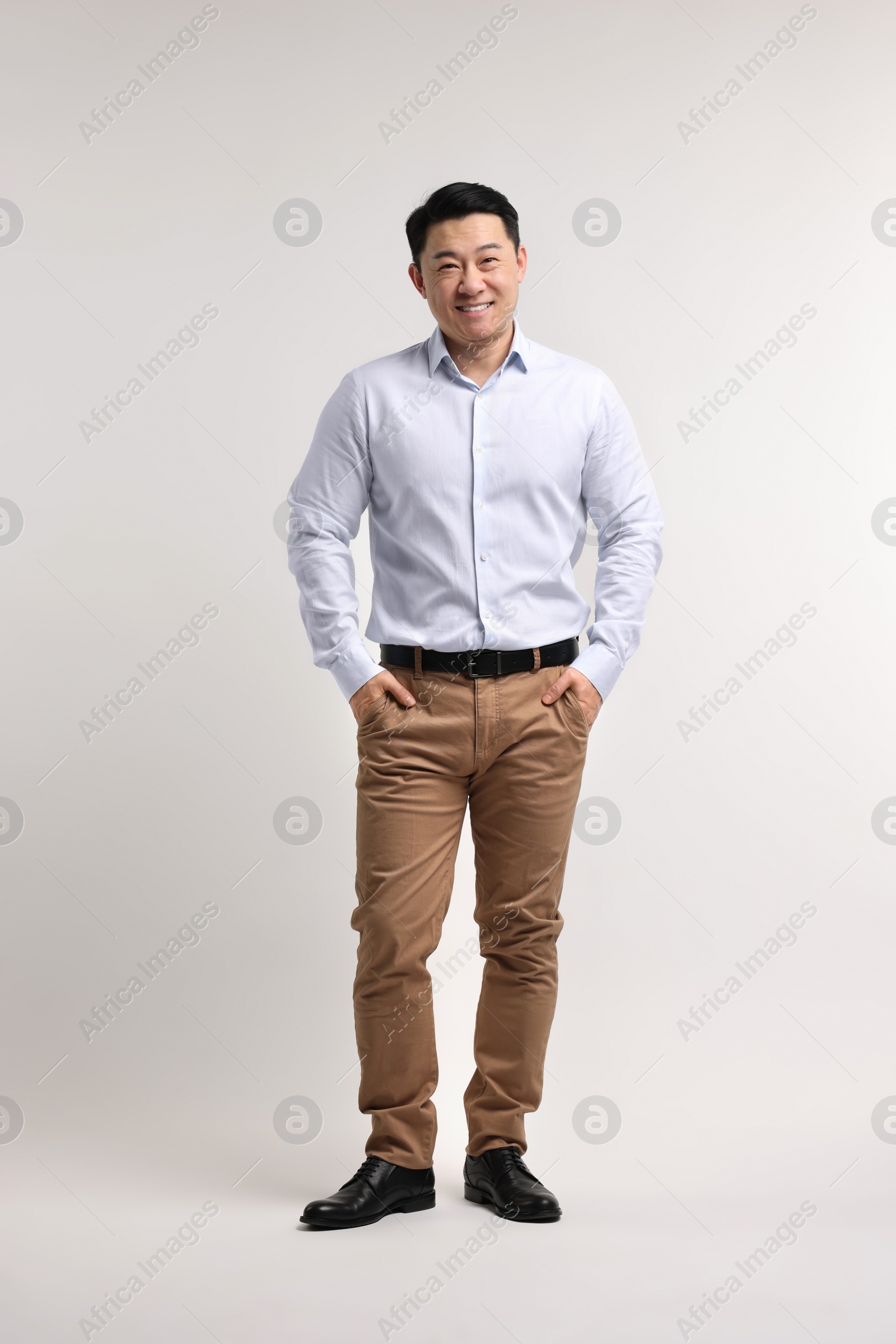 Photo of Full length portrait of happy man on light background