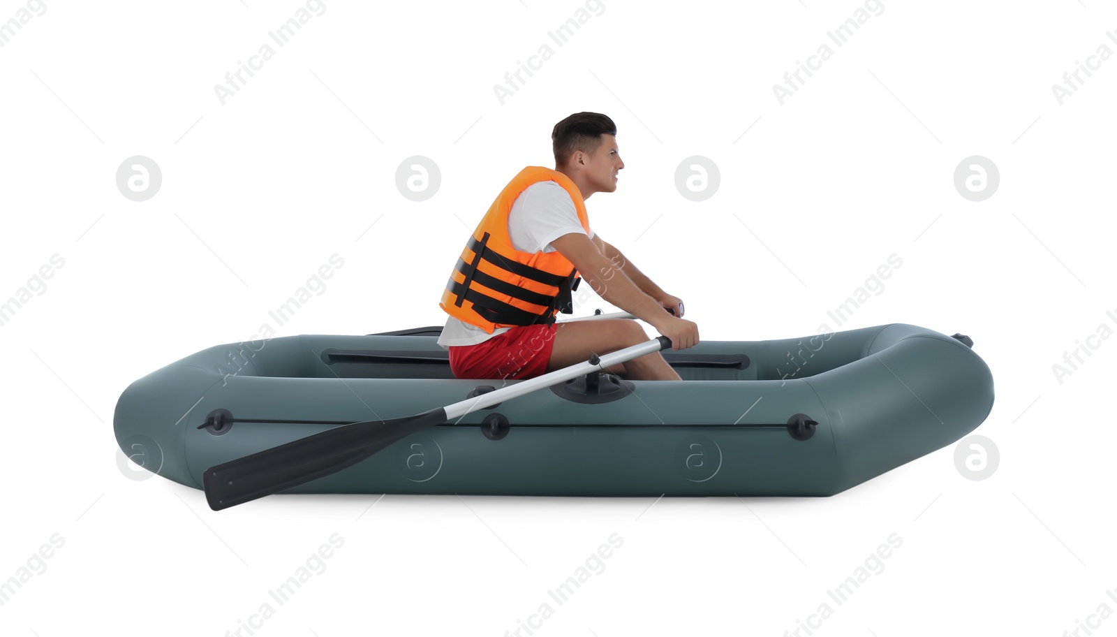 Photo of Man in life vest rowing inflatable rubber boat on white background