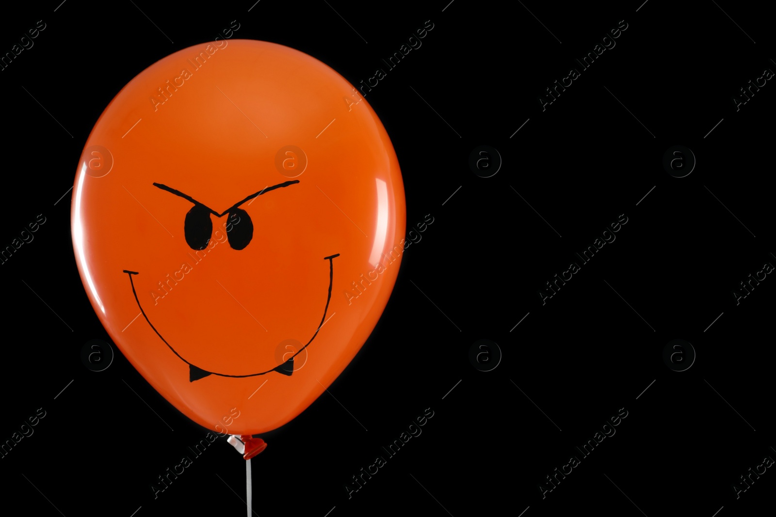 Photo of Spooky balloon for Halloween party on black background, space for text