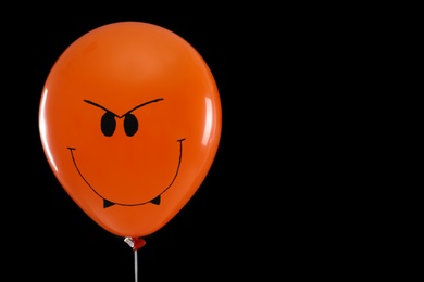 Photo of Spooky balloon for Halloween party on black background, space for text