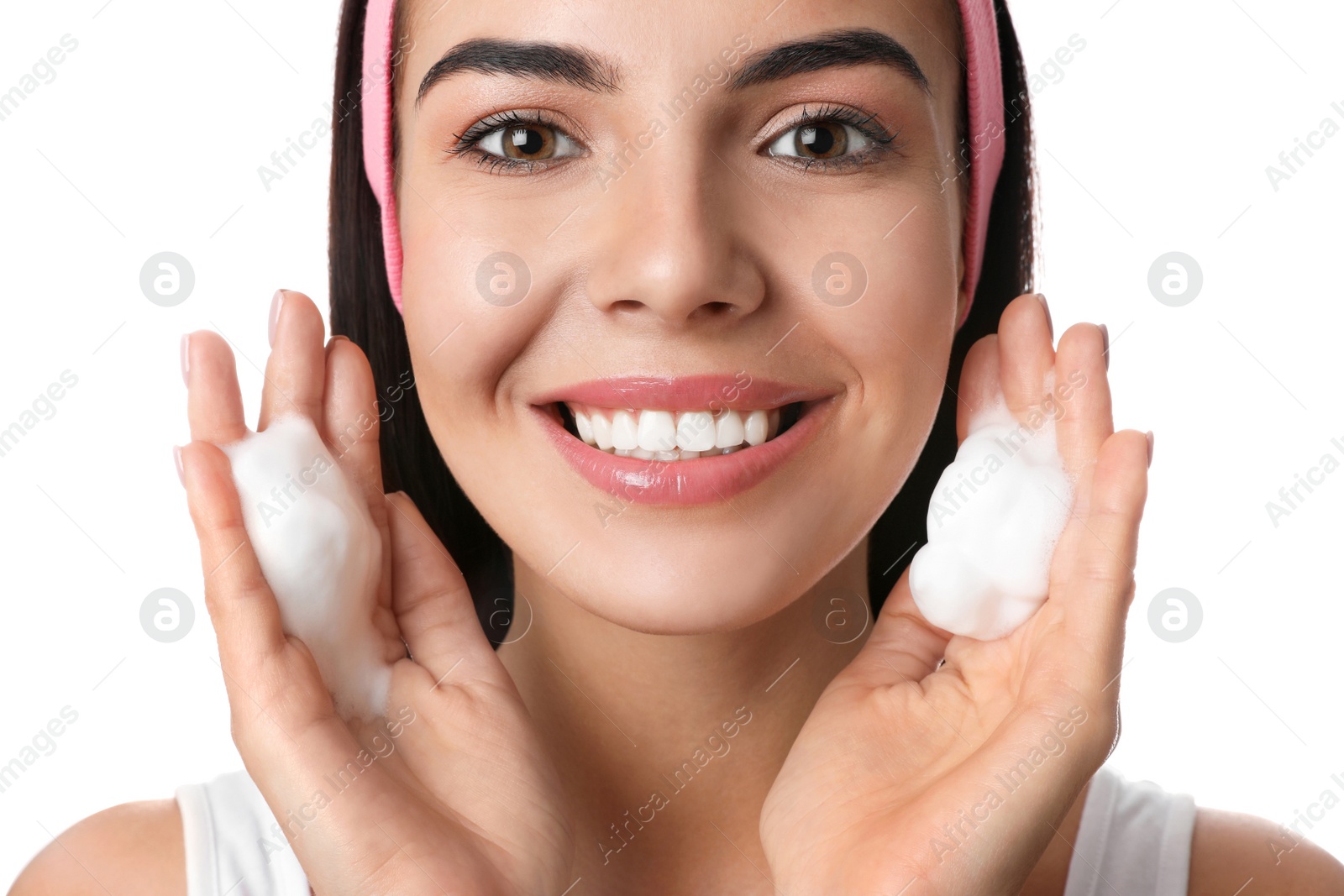 Photo of Young woman applying cosmetic product on white background, closeup. Washing routine