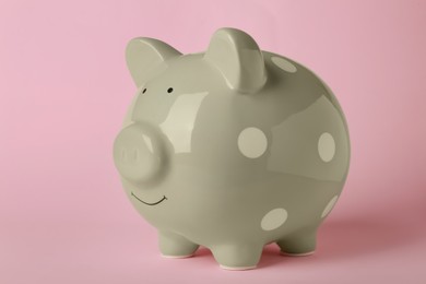 Ceramic piggy bank on pink background. Financial savings
