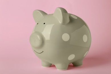 Photo of Ceramic piggy bank on pink background. Financial savings