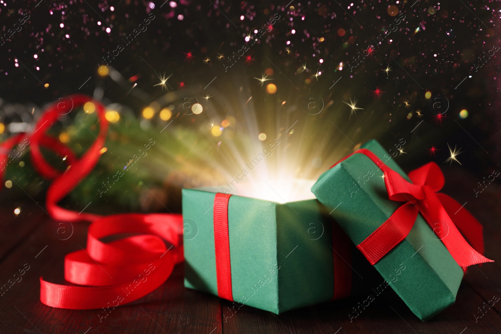 Image of Beautiful Christmas gift box with magic light on table