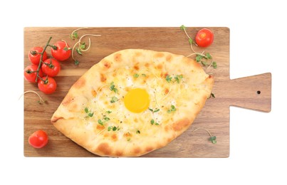 Fresh delicious Adjarian khachapuri with microgreens and tomatoes on white background, top view