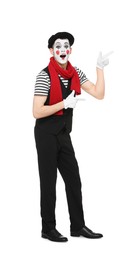 Photo of Funny mime artist in beret pointing at something on white background