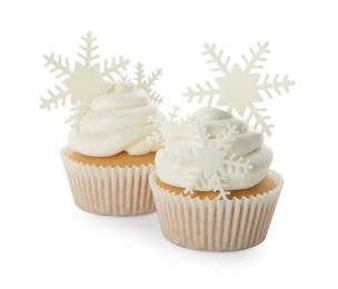 Tasty Christmas cupcakes with snowflakes on white background