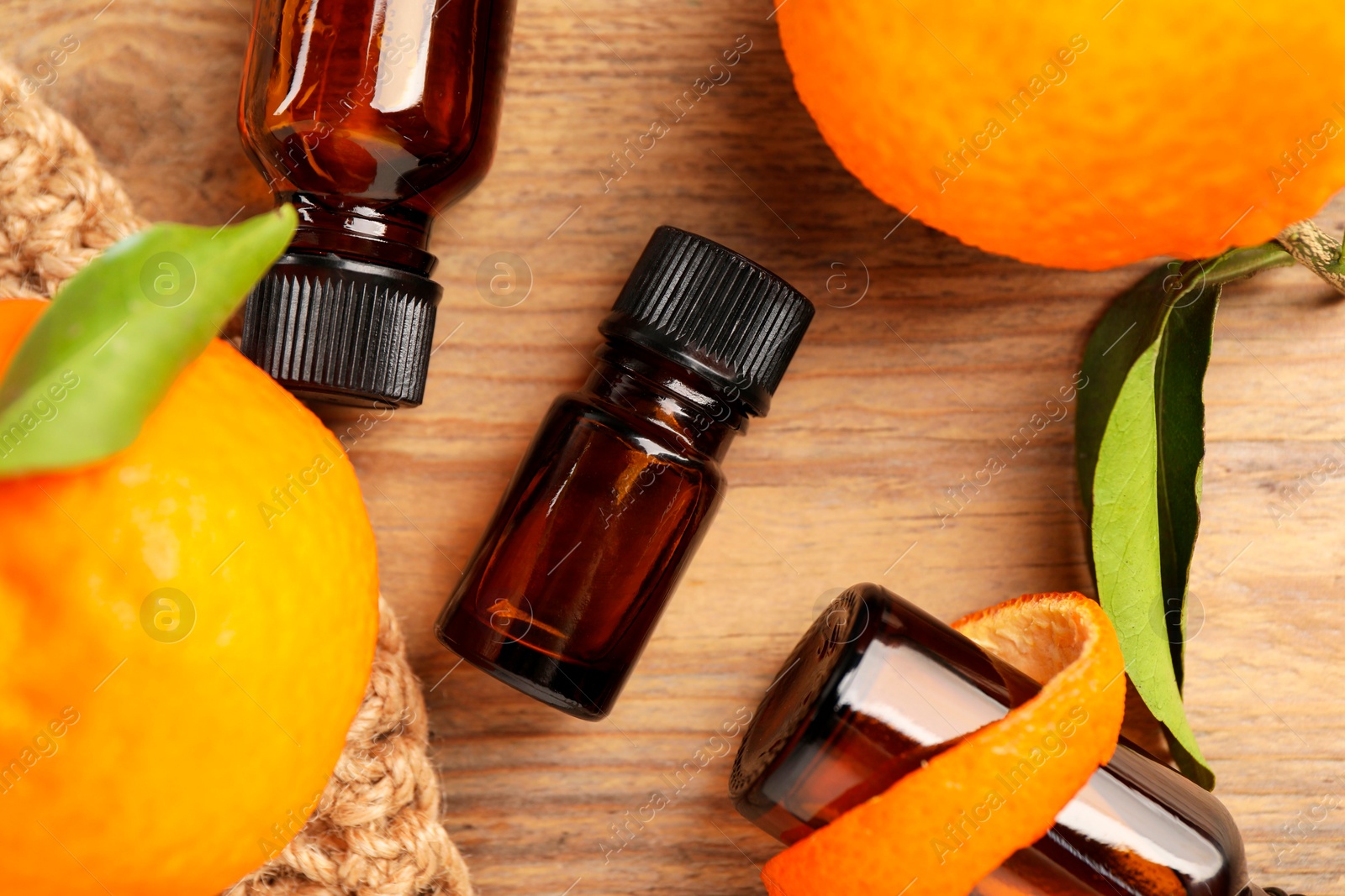 Photo of Flat lay composition with tangerine essential oil on wooden table