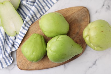 Fresh green chayote on light marble table, top view