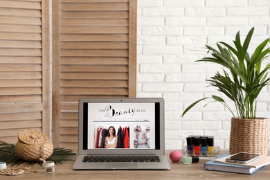 Laptop with open beauty blogger site on table