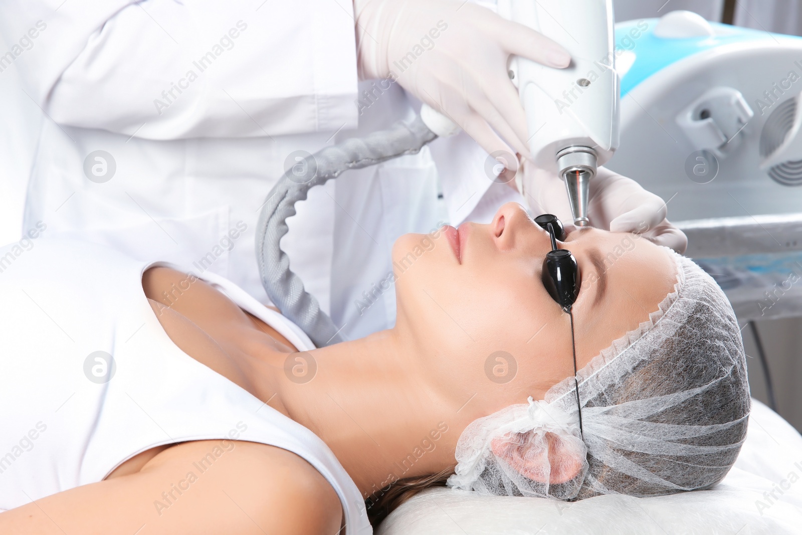 Photo of Young woman undergoing laser removal of permanent makeup in salon. Eyebrow correction