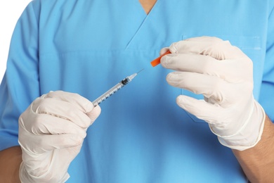 Male doctor with insulin syringe, closeup. Medical object