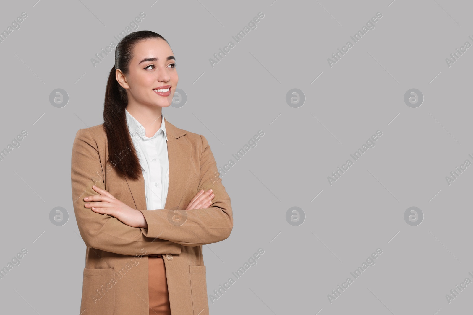 Photo of Happy real estate agent on grey background. Space for text