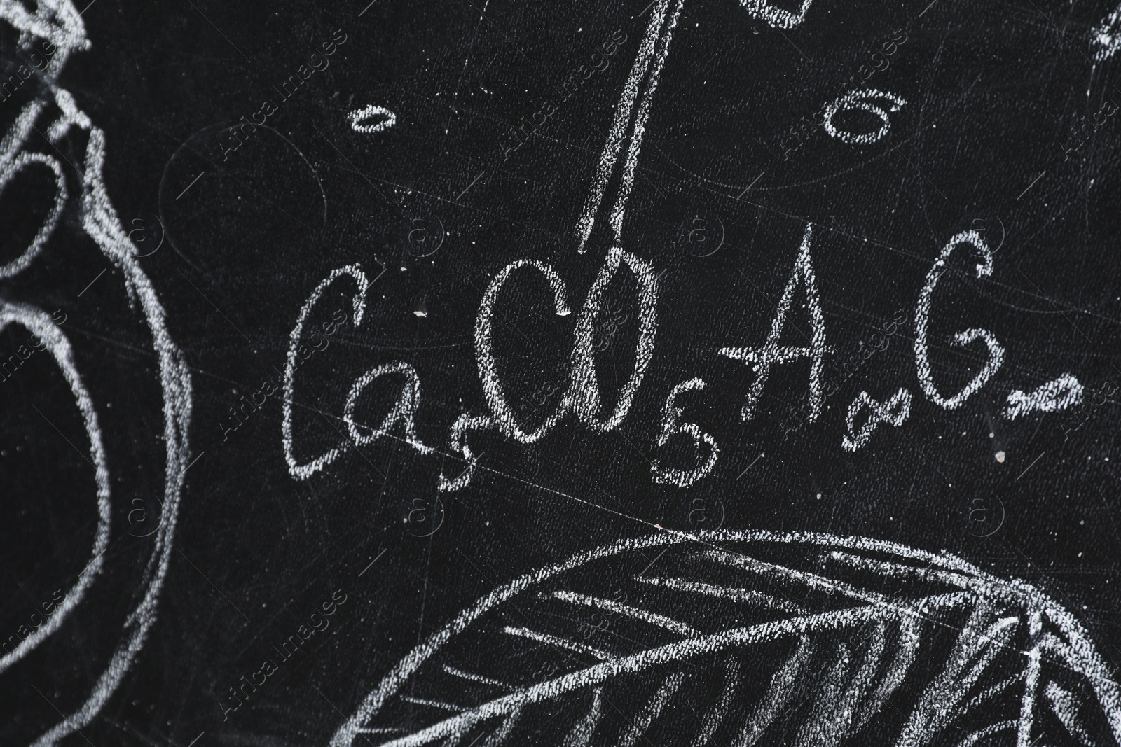 Photo of Chemical formulas and different pictures drawn on blackboard