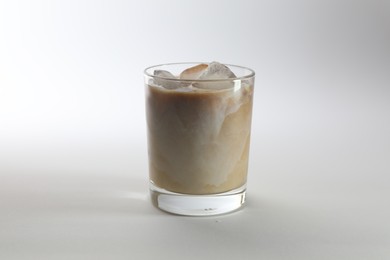 Photo of Iced coffee with milk in glass on white background